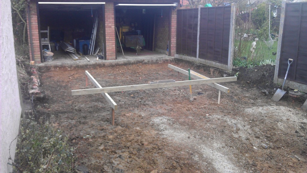 Driveway pegged for depth, ready for base.